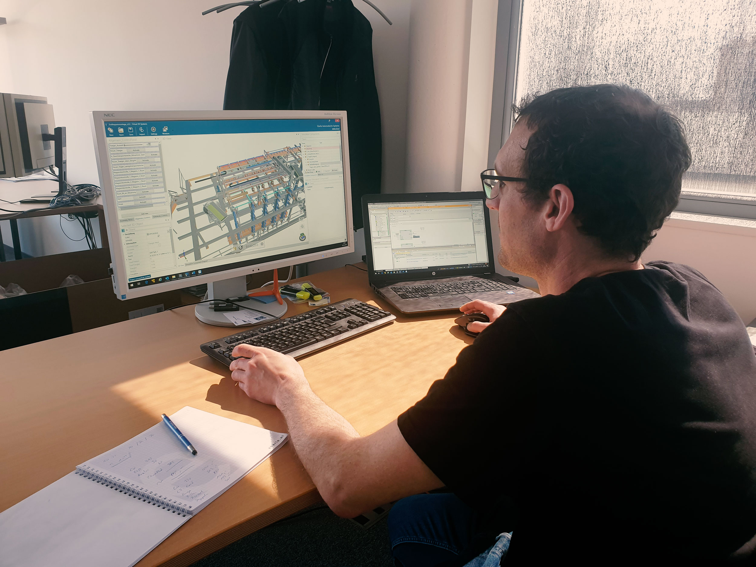 Control engineer testing the digital twin of a special-purpose machine on screen